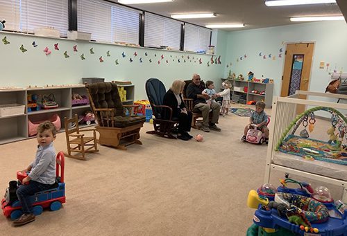 room with rocking chairs toys and other items for young children